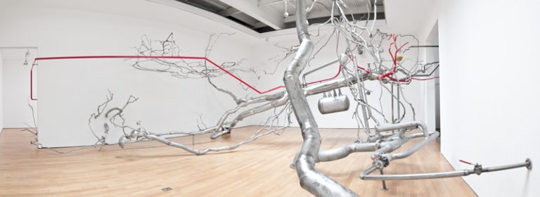 Roxy Paine, Distillation, 2010, stainless steel, glass, rubber, oil paint, sulphur, pigment, 5.46X13.7X11.9 meter.